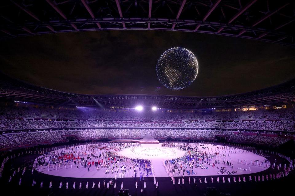 A drone display is seen over the top of the stadium during the opening ceremony.