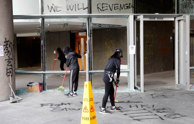 Anti-government protesters clean up after protests at the Polytechnic University in Hong Kong