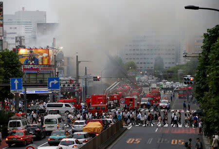 Firefighters operate at the fire site at Tokyo's Tsukiji fish market in Tokyo, Japan August 3, 2017. REUTERS/Toru Hanai