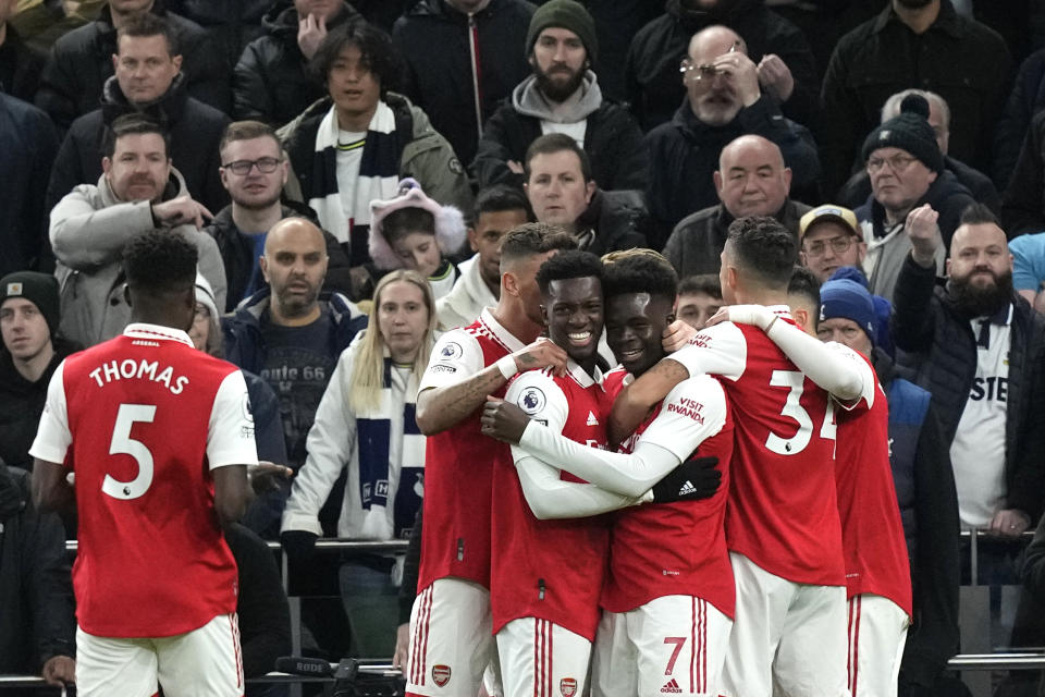 Arsenal players celebrate after scoring during the English Premier League soccer match between Tottenham Hotspur and Arsenal at the Tottenham Hotspur Stadium in London, England, Sunday, Jan. 15, 2023. (AP Photo/Frank Augstein)