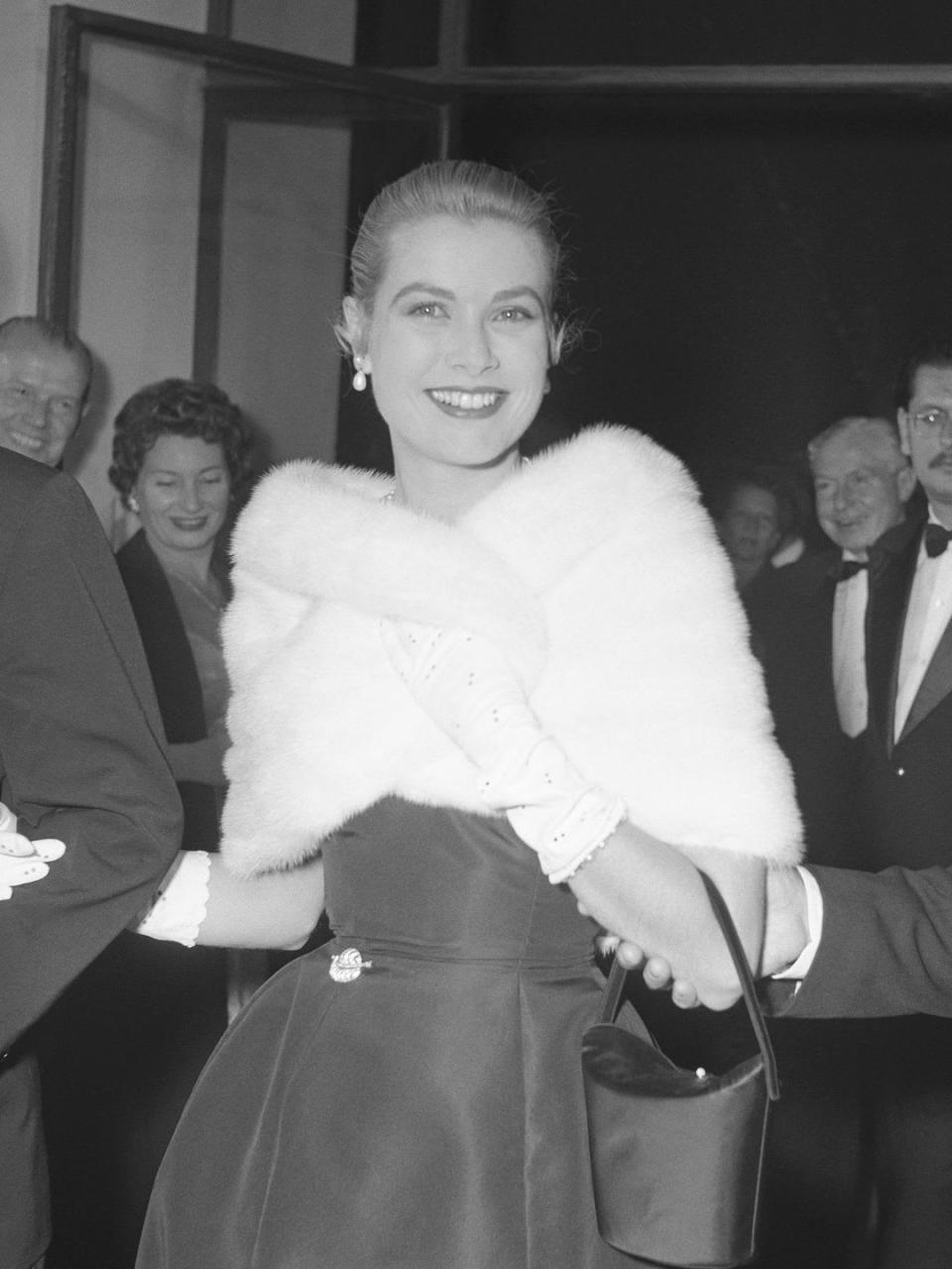 Grace Kelly in a fluffy stole at a party during the Cannes Film Festival 