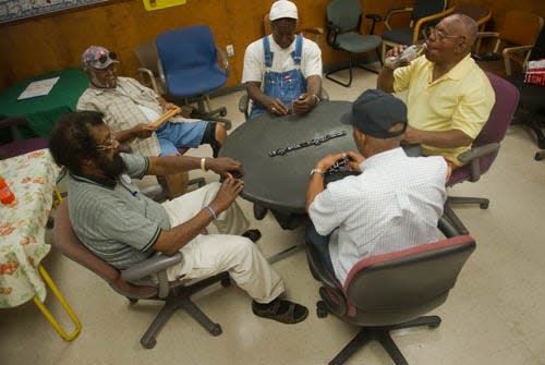 From left, Lee Vurn Jones, Herbert Martin, Joe Warren, Joe Kelly and Thaddeus Bush play dominoes at the Taft Community Center, which is designated as a "cool zone" in south Stockton.