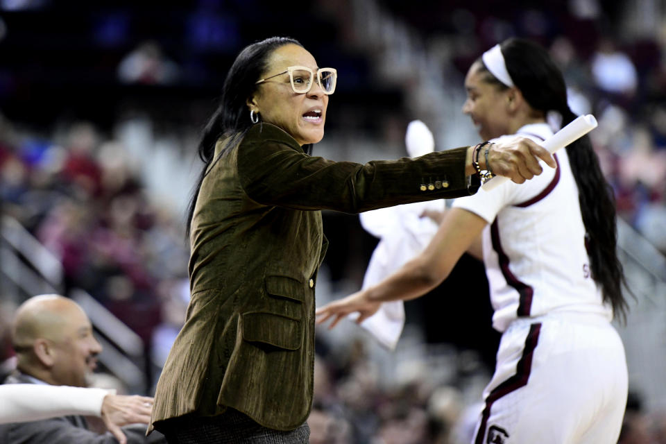 South Carolina coach Dawn Staley, left, communicates with players during the first half of an NCAA college basketball game against Arkansas, Thursday, Jan. 9, 2020, in Columbia, S.C. (AP Photo/Sean Rayford)