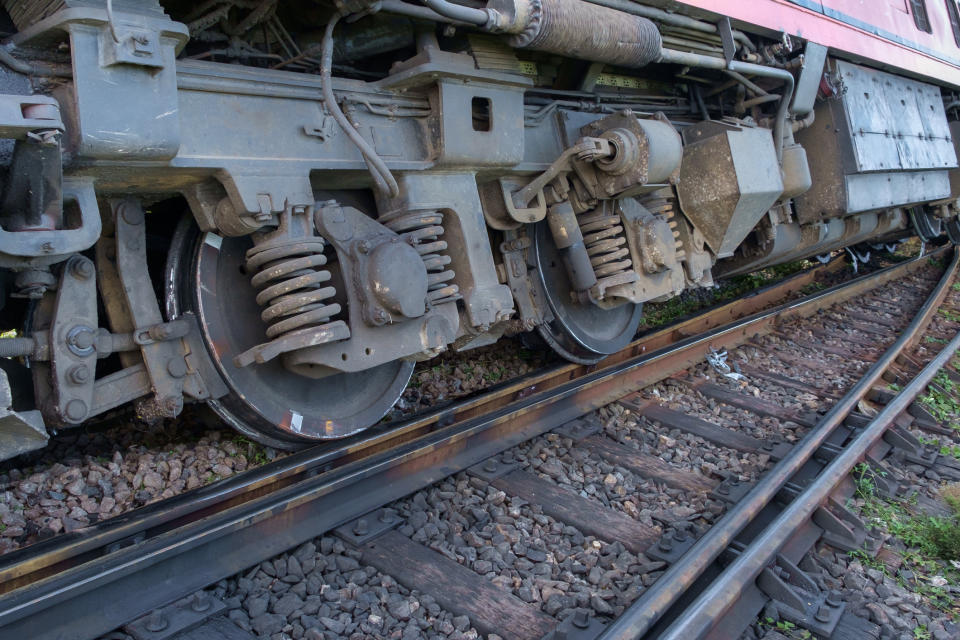 closeup of the wheels of a train derailed