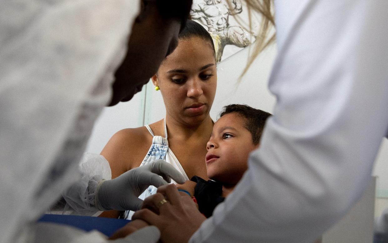 A young boy participating in a dengue vaccine trial in Brazil, taken by Adrienne Surprenant and submitted in the inaugural Wellcome Photography Prize 2019 - Adrienne Surprenant / Collectif Item
