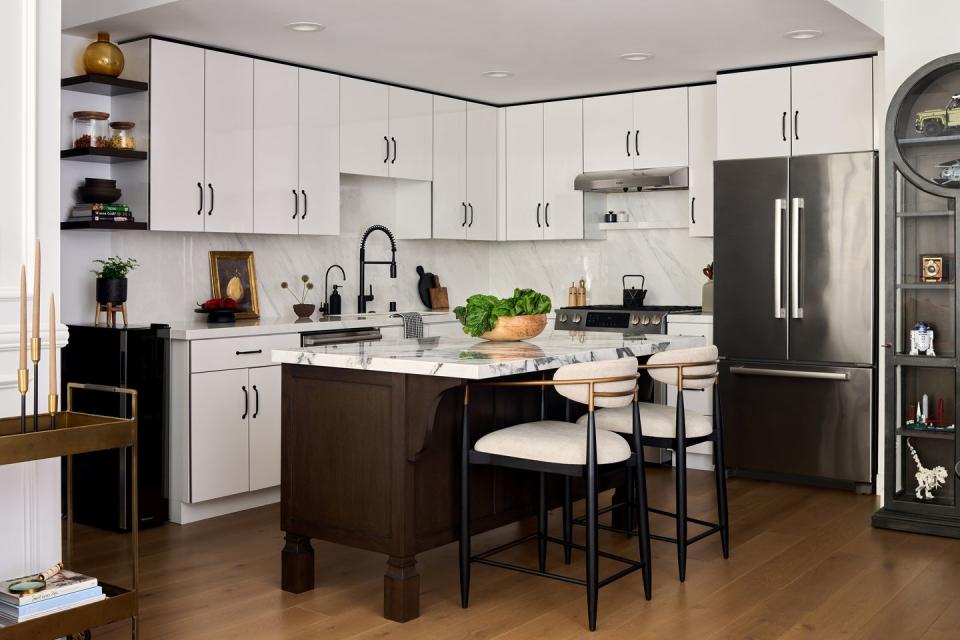 kitchen with an island and two chairs in the middle