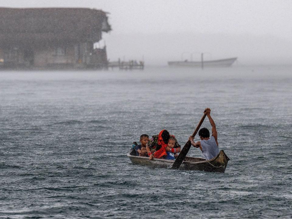 A family in a boat paddling near Carti Sugtupu.