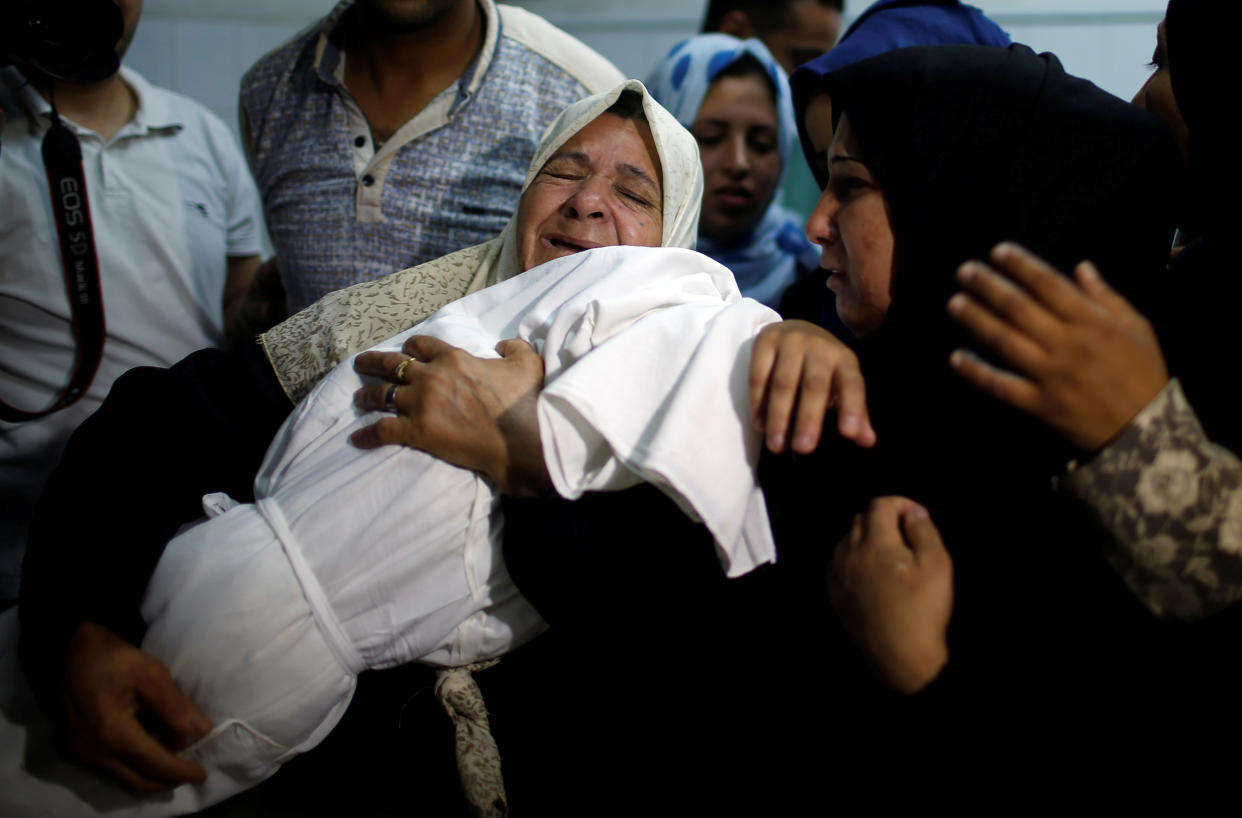 A relative carries the body of 8-month-old Palestinian infant Laila al-Ghandour, who died after inhaling tear gas during a protest against the U.S. embassy move to Jerusalem, during her funeral in Gaza City, May 15, 2018. (Photo: Mohammed Salem / Reuters)