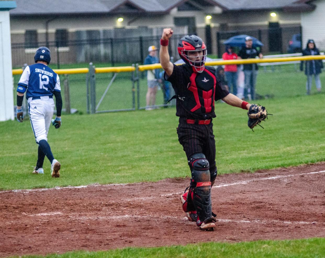 JoBurg catcher Collin Lake celebrates after throwing out a runner at third base to complete a game-ending double-play against Gaylord St. Mary on Tuesday, May 7.