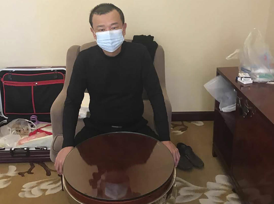 In this photo taken on Feb. 19, 2020 and released by Chen Chi-chuan, Chen Chi-chuan, 51, a Taiwanese electrical and plumbing contractor poses for a photo in his room at the Vienna International Hotel where he's lived in since Jan. 28 in Shiyan city in central China's Hubei province. Chen and about 1,000 other Taiwanese citizens are stuck behind doors in locked-down Chinese cities because their government cannot agree with China on how to arrange charter flights. Some are losing business income, risking too many absences from work and wondering how their children, if also stranded, will make up lost school days. (Chen Chi-chuan via AP)