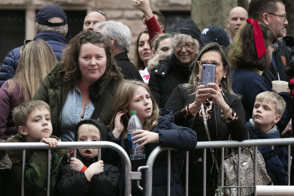 Crowds watch as the balloons for the Macy's Thanksgiving Day Parade are inflated, Wednesday, Nov. 27, 2019 in New York. The city's parade on Thursday will take place amid strong winds that could potentially ground the giant character balloons. (AP Photo/Mark Lennihan)