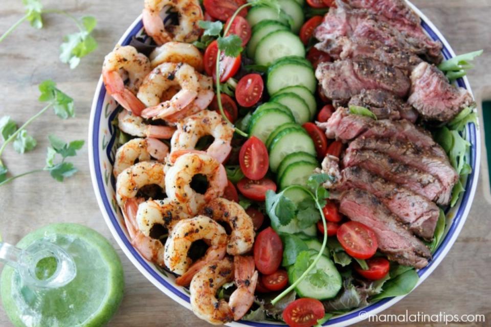 <p>This grilled surf and turf salad combines two favorites: Angus beef steak and shrimp, served on top of colorful and crunchy greens. Finish with a creamy cilantro dressing and enjoy! <strong>Get the Recipe: <a href="https://www.mamalatinatips.com/2018/06/grilled-surf-and-turf-salad-with-cilantro-dressing.html" rel="nofollow noopener" target="_blank" data-ylk="slk:Surf and Turf Salad;elm:context_link;itc:0;sec:content-canvas" class="link ">Surf and Turf Salad</a></strong></p>