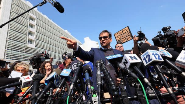 PHOTO: Rep. George Santos (R-NY) speaks with members of the press as he leaves Federal Court, May 10, 2023, in Central Islip, N.Y. (Michael M. Santiago/Getty Images)