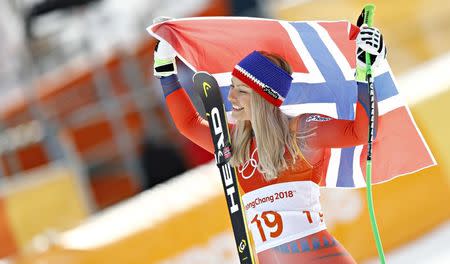 Alpine Skiing - Pyeongchang 2018 Winter Olympics - Women's Downhill - Jeongseon Alpine Centre - Pyeongchang, South Korea - February 21, 2018 - Silver medallist Ragnhild Mowinckel of Norway celebrates with the Norwegian flag during the flower ceremony. REUTERS/Kai Pfaffenbach