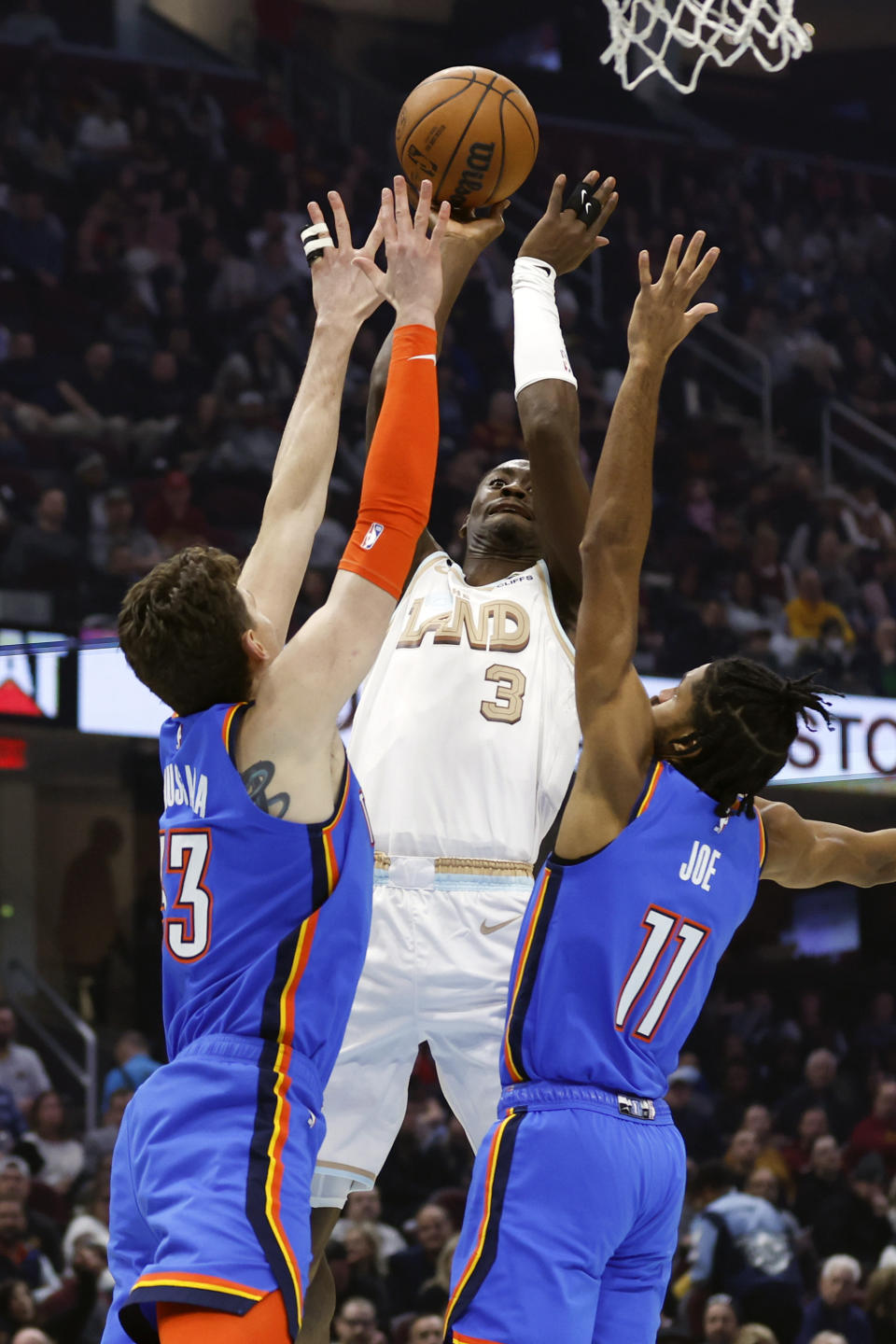 Cleveland Cavaliers guard Caris LeVert (3) shoots against Oklahoma City Thunder center Mike Muscala (33) and guard Isaiah Joe (11) during the first half of an NBA basketball game, Saturday, Dec. 10, 2022, in Cleveland. (AP Photo/Ron Schwane)