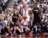 Miami Heat guard Goran Dragic (7) dribbles the ball away from Toronto Raptors guard Kyle Lowry (7) and center Jonas Valanciunas (17) as Heat center Hassan Whiteside (21) looks on in game one of the second round of the NBA Playoffs at Air Canada Centre. Mandatory Credit: Dan Hamilton-USA TODAY Sports