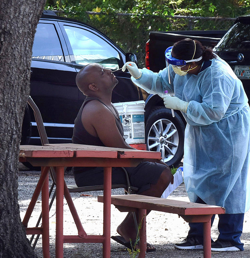 ALTAMONTE SPRINGS, UNITED STATES - APRIL 21, 2020: A health worker tests a man for COVID-19 at a mobile testing site at the Apostolic Church of Christ in a historic black neighborhood in Seminole County. State and county health officials are offering free tests at six historic black neighbourhoods to help residents who are unable to drive to a health clinic or may be unable to afford health insurance.- PHOTOGRAPH BY Paul Hennessy / Echoes Wire/ Barcroft Studios / Future Publishing (Photo credit should read Paul Hennessy / Echoes Wire/Barcroft Media via Getty Images)