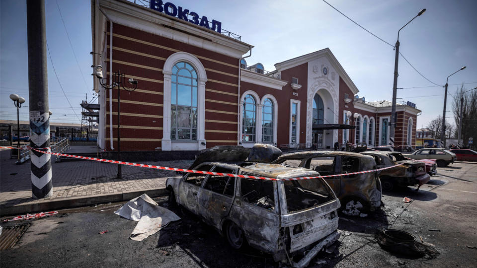 Calcinated cars are pictured outside a train station.