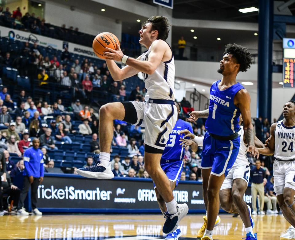 Monmouth's Jack Collins drives against Hofstra's Aaron Estrada on Feb. 11, 2023 in West Long Branch.