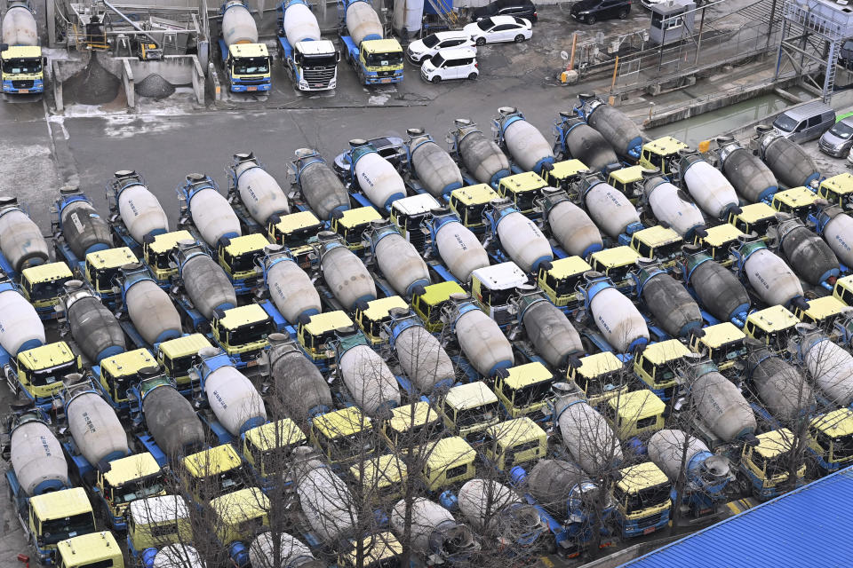 Concrete mixer trucks are parked at a factory in Anyang, South Korea, Monday, Nov. 28, 2022. South Korea’s government issued an order Tuesday for some of the thousands of striking truck drivers to return to work, insisting that their nationwide walkout over freight fare issues is hurting an already weak economy. (Kim Jong-taek/Newsis via AP)