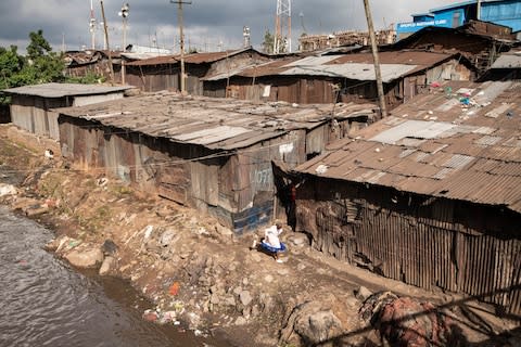 The bodies of babies are often found dumped in the river that runs through the slum - Credit: Simon Townsley/The Telegraph