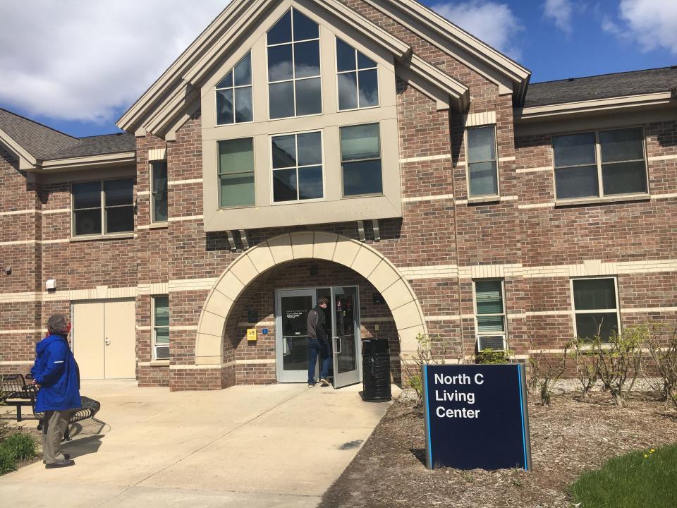 Andy Beachnau, associate vice provost of student affairs and director of housing and health services at Grand Valley State University, waits for another staff member to enter a living center on Grand Valley's Allendale campus on Monday, May 11.
