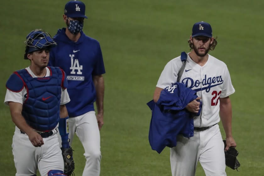 Arlington, Texas, Wednesday, October 7, 2020. Los Angeles Dodgers starting pitcher Clayton Kershaw (22) walks to the dugout with catcher Austin Barnes and pitching coach Mark Prior before taking on the Padres in game two of the NLDS at Globe Life Field. (Robert Gauthier/ Los Angeles Times)