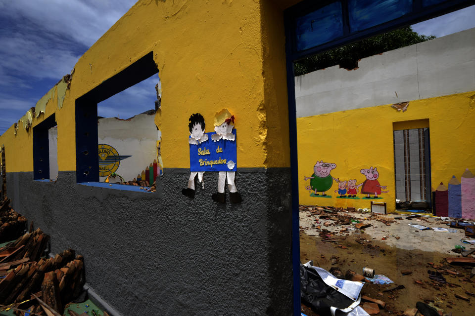 The ruins of an abandoned school stand in the Pinheiro neighborhood Maceio, Alagoas state, Brazil, Sunday, March 6, 2022. The school was abandoned because the threat of ground subsidence caused by the Braskem mine that has forced more than 55 thousand people from their homes in Maceio. (AP Photo/Eraldo Peres)