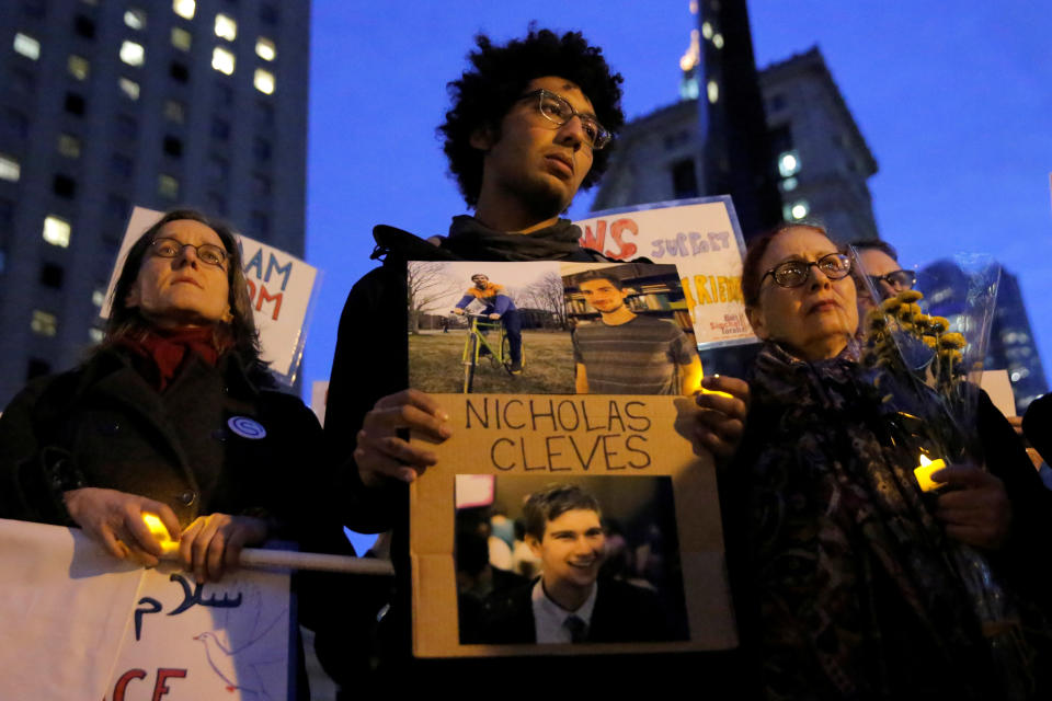 <p>Bahij Chancey (C) stands with a sign featuring his friend, New York West Side Highway pickup truck attack victim Nicholas Cleves, during a vigil in Foley Square in Manhattan, New York, Nov. 1, 2017. (Photo: Andrew Kelly/Reuters) </p>