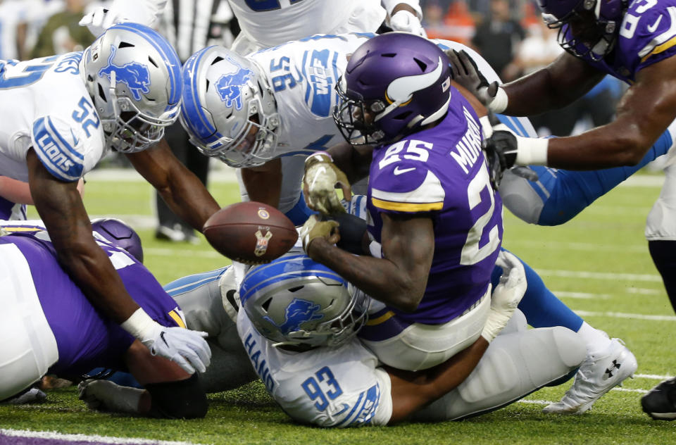 <p>Minnesota Vikings running back Latavius Murray (25) loses the ball as he scores on a 1-yard touchdown run over Detroit Lions defensive end Da’Shawn Hand (93) during the first half of an NFL football game, Sunday, Nov. 4, 2018, in Minneapolis. (AP Photo/Bruce Kluckhohn) </p>