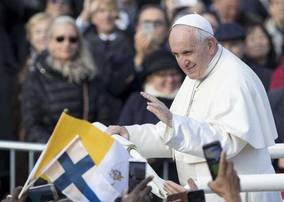 Pope Francis greets people as he arrives for a Holy Mass at the Freedom square in Tallinn, Estonia, Tuesday, Sept. 25, 2018. Pope Francis arrived in Estonia for a one-day visit Tuesday. (AP Photo/Mindaugas Kulbis)