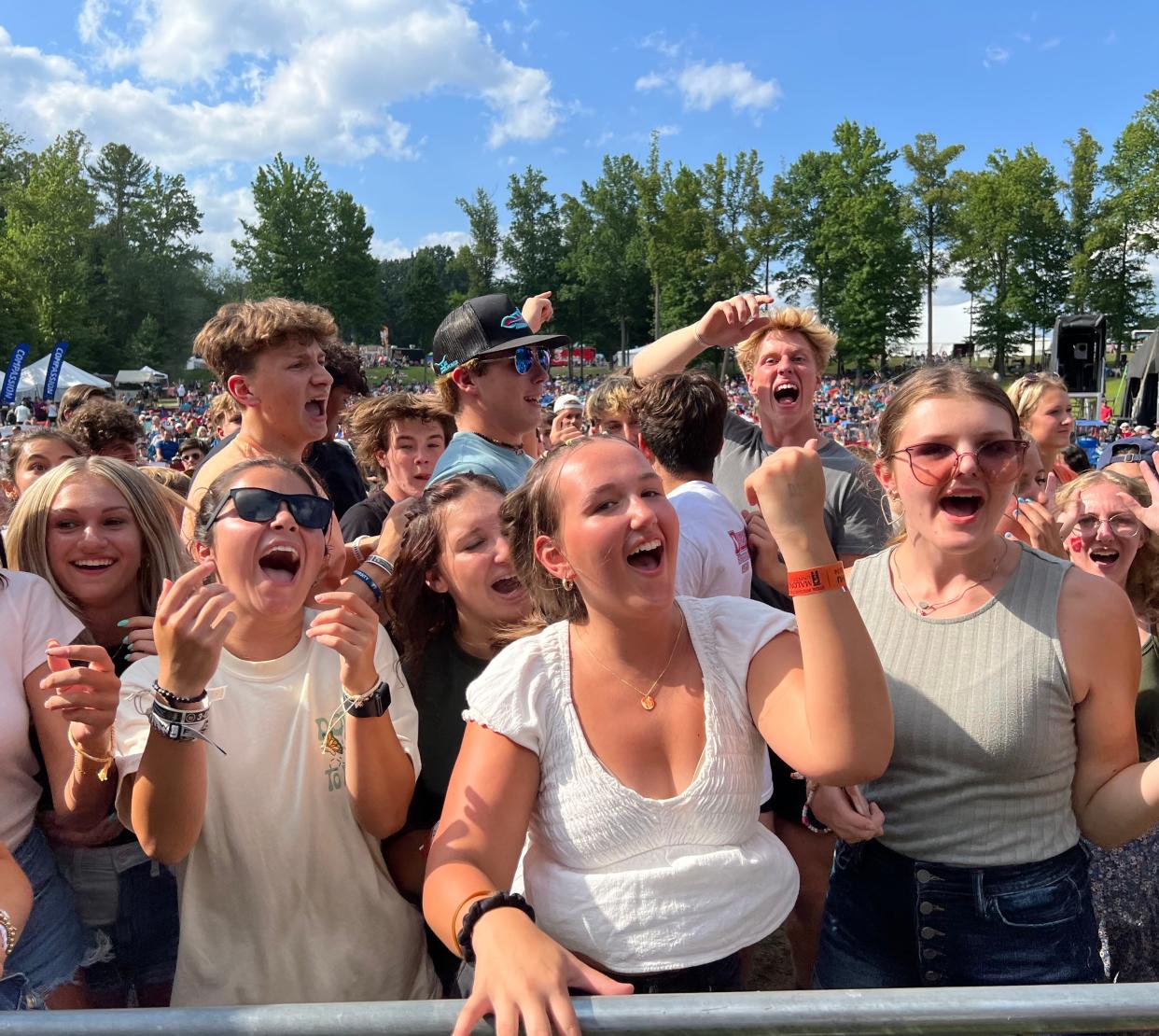 A group of friends enjoy the Caleb Gordon hip-hop concert on Thursday afternoon at the Alive Music Festival at Atwood Lake Park. The event continues with headliners Jeremy Camp on Friday and Skillet on Saturday.