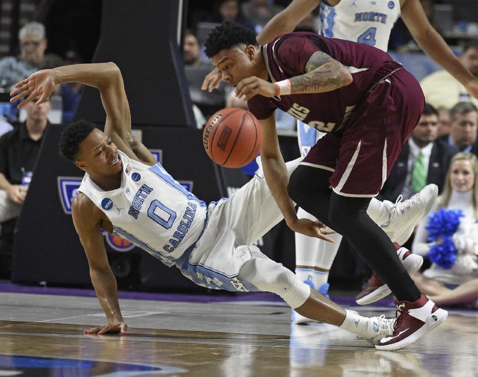 Texas Southern's Zach Lofton (2) runs into North Carolina's Nate Britt (0) during the first half in a first-round game of the NCAA men's college basketball tournament in Greenville, S.C., Friday, March 17, 2017. (AP Photo/Rainier Ehrhardt)