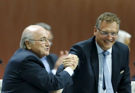 FIFA President Sepp Blatter (L) and Jerome Valcke, Secretary General of the FIFA do a Handshake For Peace at the 65th FIFA Congress in Zurich, Switzerland, in this May 29, 2015 file photo. REUTERS/Ruben Sprich/Files