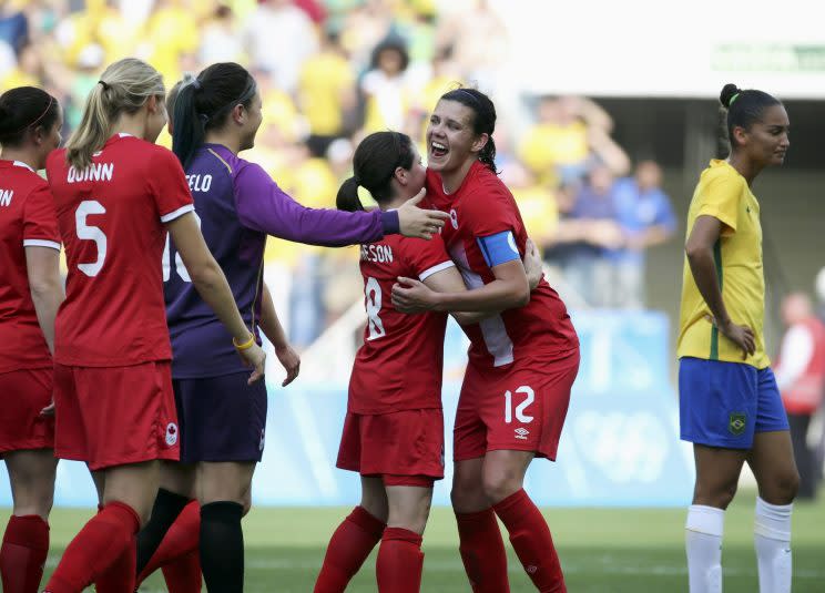 Christine Sinclair and Diana Matheson of Canada celebrate after defeating Brazil in Rio. REUTERS/Paulo Whitaker 