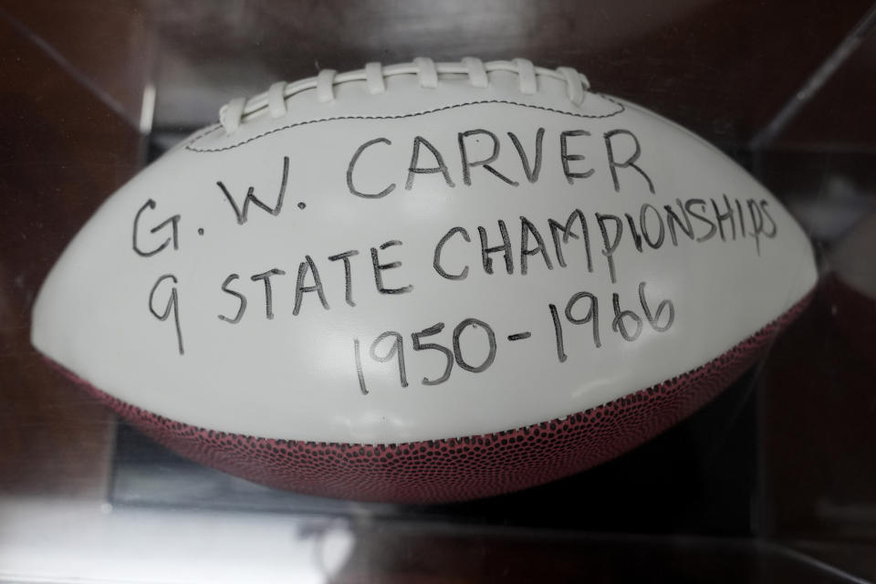 A football with the name of George Washington Carver School is displayed in the Coconut Grove Sports Hall of Fame in the Miami neighborhood of west Coconut Grove, Thursday, Feb. 15, 2024. The majority-Black neighborhood — known by names such as West Grove, Black Grove, or even Little Bahamas, in a nod to its Bahamian roots — has nurtured the early careers of numerous notable sports figures, from Olympic Gold medalists to NFL Hall of Famers like Frank Gore and Amari Cooper, as well as housed successful Black business owners and stalwarts who played a vital role in city's history and culture. (AP Photo/Lynne Sladky)