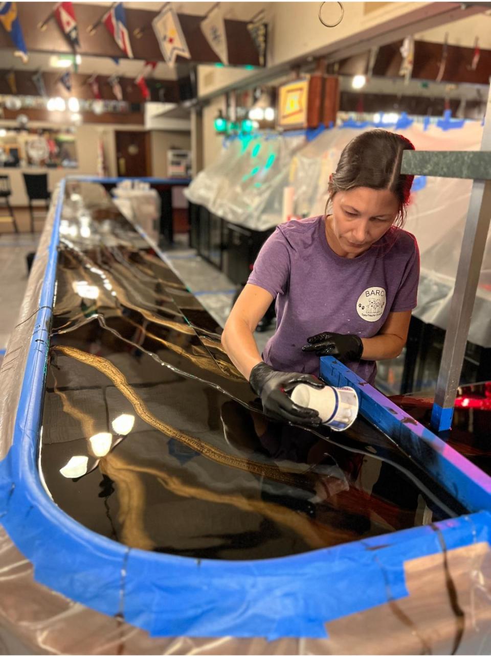 Denning works on a commercial bar top for a customer that can that can take daily use.