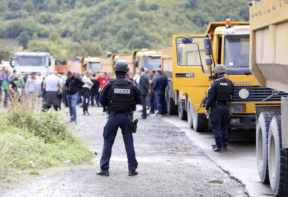 Kosovo special police stand on the road near the northern Kosovo border crossing of Jarinje, Monday, Sept. 20, 2021. Tensions soared Monday at the border between Kosovo and Serbia as Kosovo deployed additional police to implement a rule to remove Serbian license plates from cars entering Kosovo, while Serbs protested the move. (AP Photo/Bojan Slavkovic)