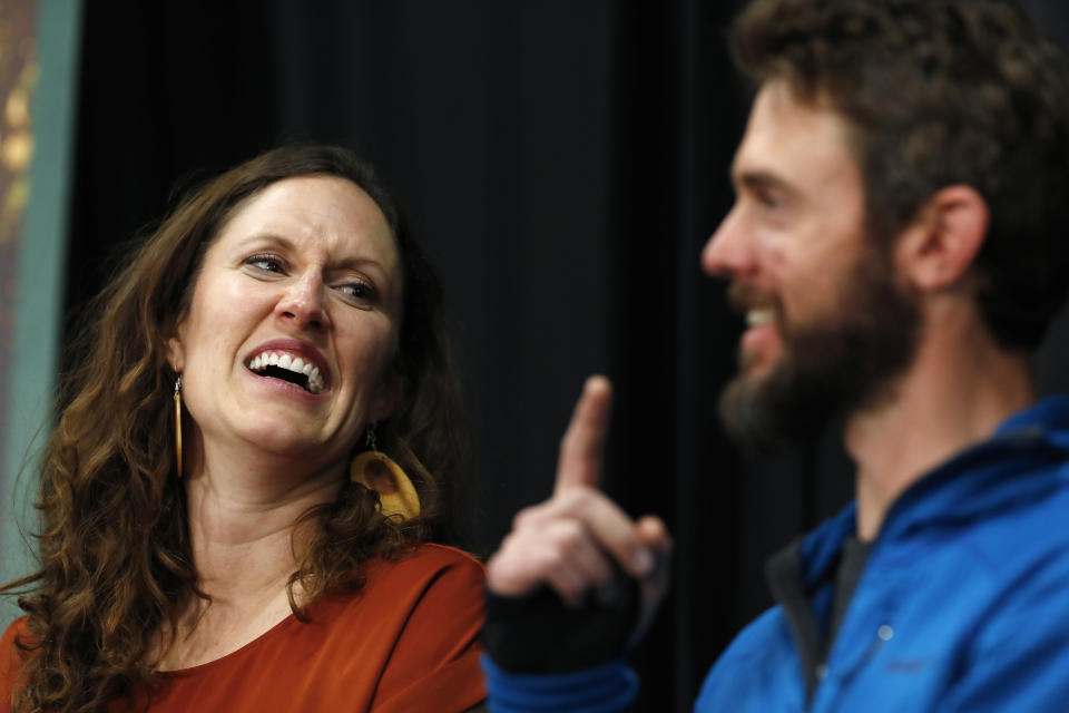 Travis Kauffman, front, responds to questions during a news conference Thursday, Feb. 14, 2019, in Fort Collins, Colo., about his encounter with a mountain lion while running a trail just west of Fort Collins last week. Kaufman's girlfriend, Annie Bierbower, looks on. (AP Photo/David Zalubowski)