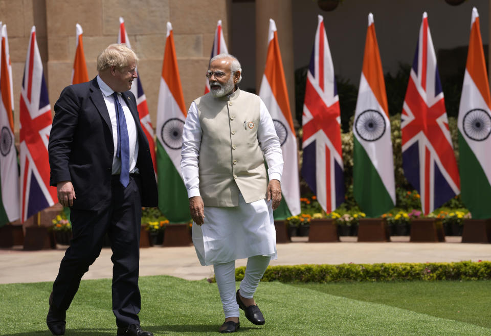 Indian Prime Minister Narendra Modi talks with his British counterpart Boris Johnson before their delegation level talks in New Delhi, Friday, April 22, 2022. Johnson is expected to help move India away from its dependence on Russia by expanding economic and defense ties when he meets with his Indian counterpart Friday, officials said. (AP Photo/Manish Swarup)