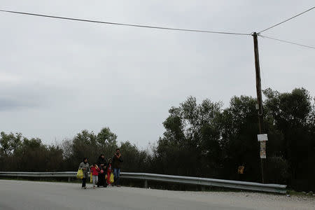 A family from Syria walks towards a makeshift camp for refugees and migrants next to the Moria camp on the island of Lesbos, Greece, December 2, 2017. REUTERS/Alkis Konstantinidis