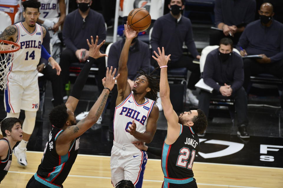 Philadelphia 76ers guard Tyrese Maxey (0) shoots between Memphis Grizzlies forward Xavier Tillman (2) and guard Tyus Jones (21) during the first half of an NBA basketball game Saturday, Jan. 16, 2021, in Memphis, Tenn. (AP Photo/Brandon Dill)