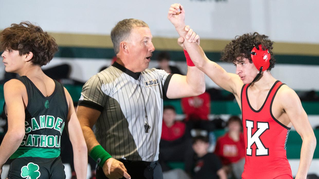 Kingsway's Jason Meola, right, has his arm raised after Meola defeated Camden Catholic's Lazarus Joyce, 8-5, during the 106 lb. bout of the wrestling meet held at Camden Catholic High School in Cherry Hill on Friday, January 27, 2023.  