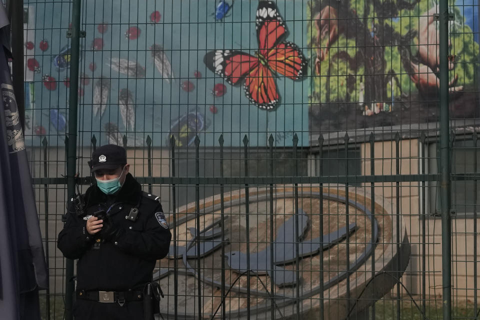 A police officer stands on duty near art work outside the U.S. Embassy in Beijing, China, Tuesday, Nov. 16, 2021. U.S. President Joe Biden opened his virtual meeting with China's President Xi Jinping by saying the goal of the two world leaders should be to ensure that competition between the two superpowers "does not veer into conflict." (AP Photo/Ng Han Guan)