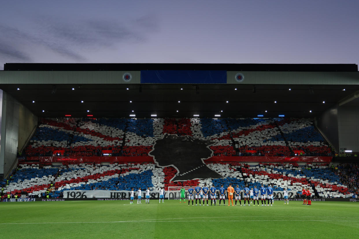 Glasgow Rangers fans display a mural of the Union Jack flag to pay tribute to Queen Elizabeth II, during a minutes silence in the Champions League match against Napoli.