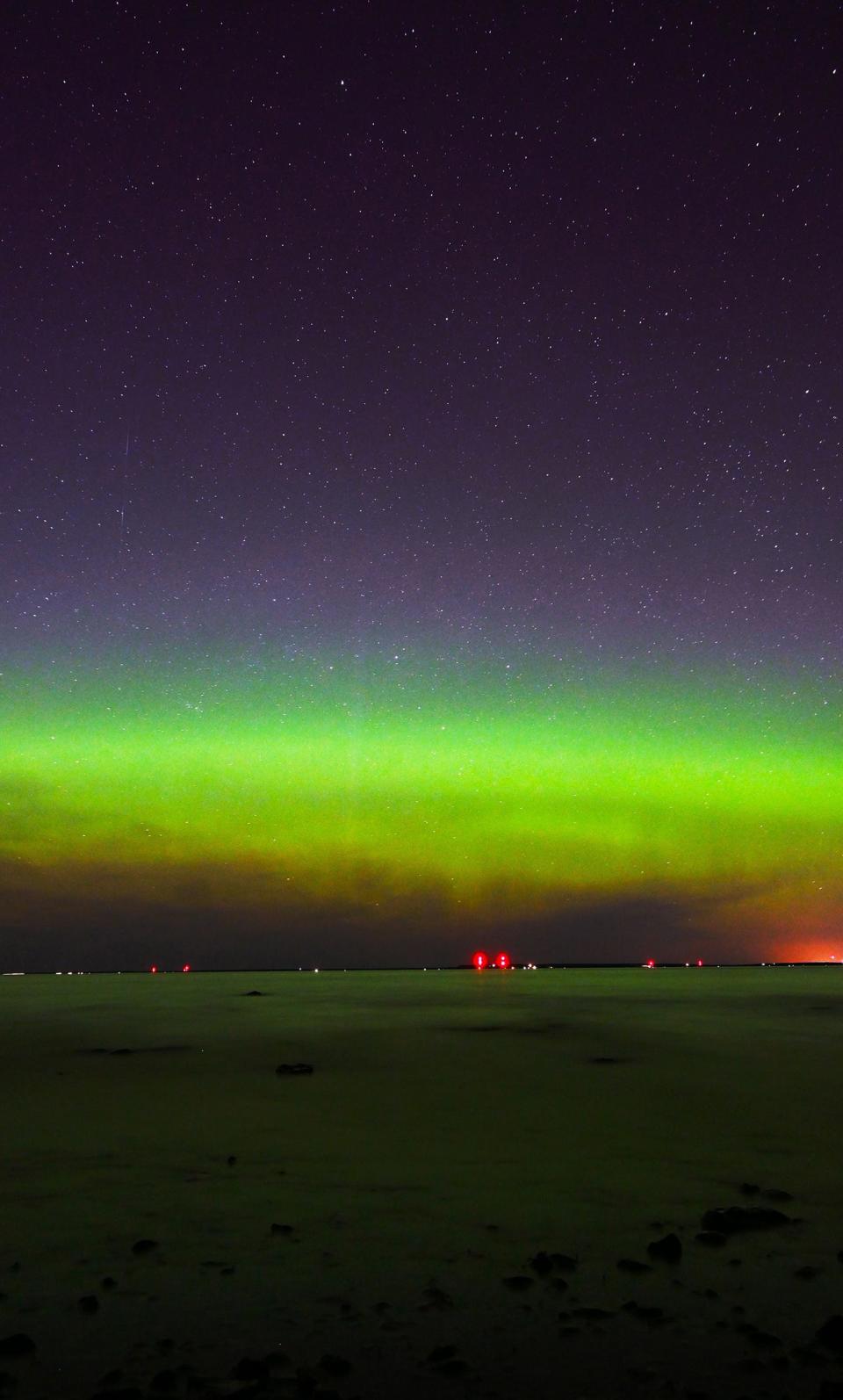 The northern lights are visible from Wilderness State Park in northern Emmet County, looking out over Lake Michigan, around 11:30 p.m. on May 11, 2024.