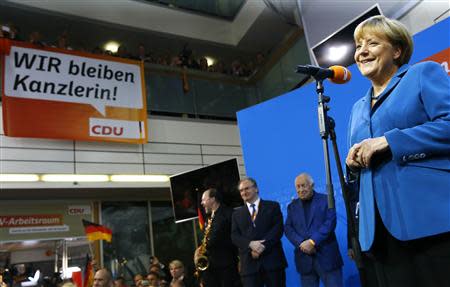 German Chancellor and leader of the Christian Democratic Union (CDU) Angela Merkel addresses supporters as she celebrates with party members after first exit polls in the German general election (Bundestagswahl) at the CDU party headquarters in Berlin September 22, 2013. REUTERS/Kai Pfaffenbach