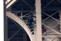 Eiffel Tower closed as man climbs upper section of 1,000ft Paris landmark