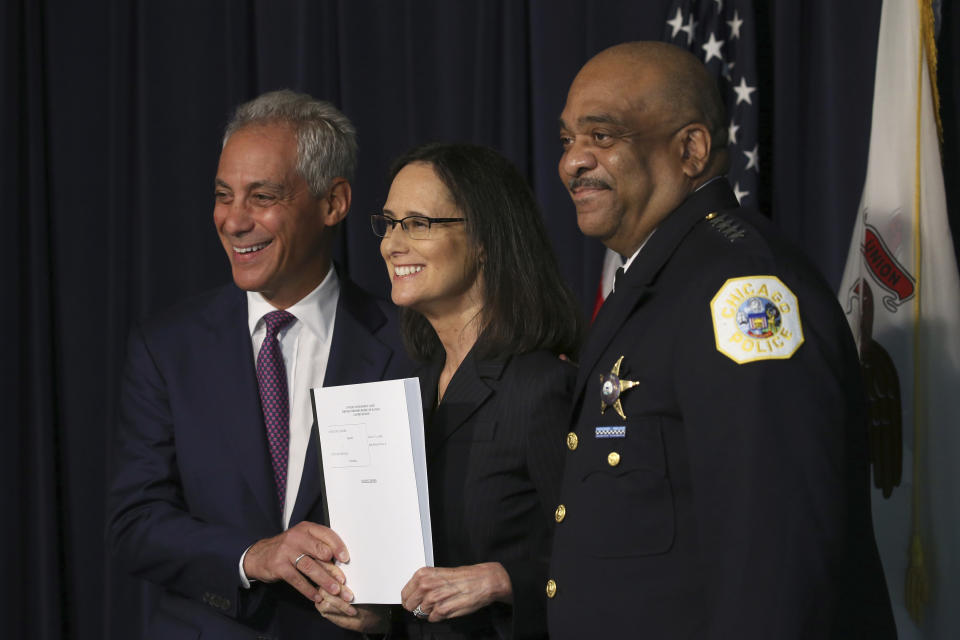 Attorney General Lisa Madigan, flanked by Chicago police Superintendent Eddie Johnson and Mayor Rahm Emanuel hold up a copy of the proposed consent decree during a news conference, Thursday, Sept. 13, 2918 in Chicago. The 226-page document was submitted Thursday to a Chicago federal judge. (Antonio Perez /Chicago Tribune via AP)