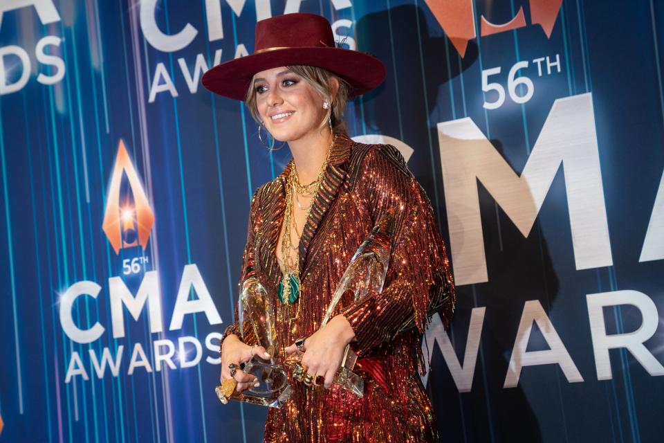 Lainey Wilson poses with her awards for female vocalist of the year and best new artist at the 56th CMA Awards.